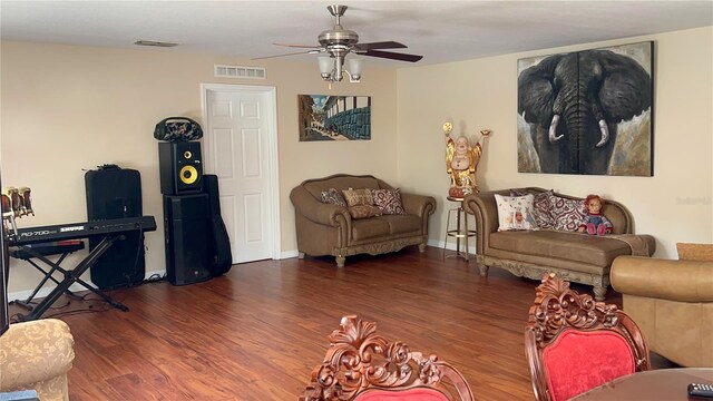 living area with ceiling fan, wood finished floors, and visible vents