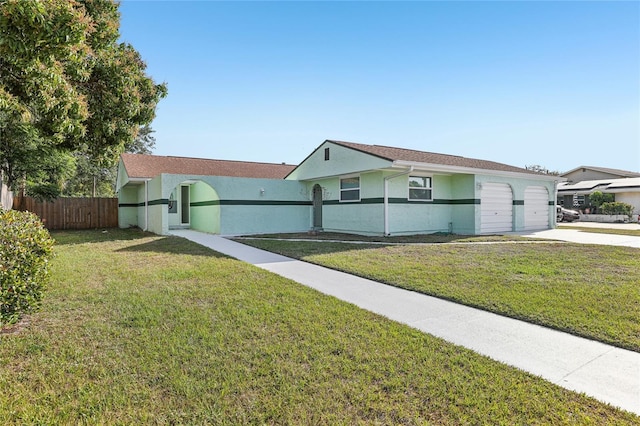 single story home featuring concrete driveway, fence, an attached garage, a front yard, and stucco siding