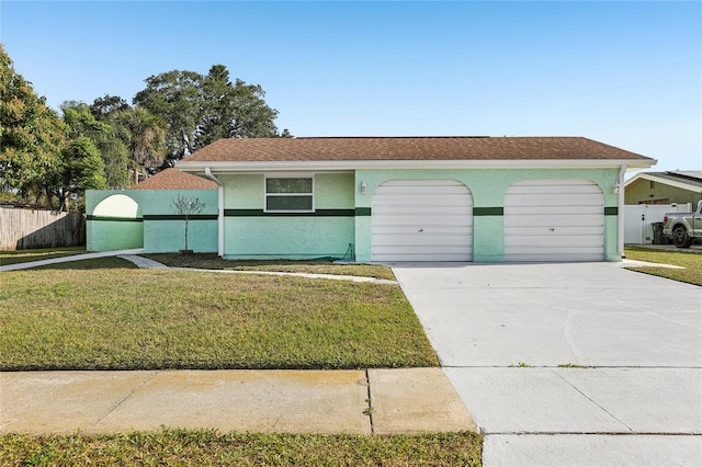 ranch-style house with a front lawn, driveway, fence, a garage, and stucco siding