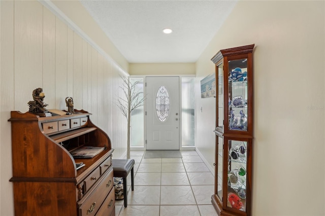 foyer entrance with light tile patterned floors