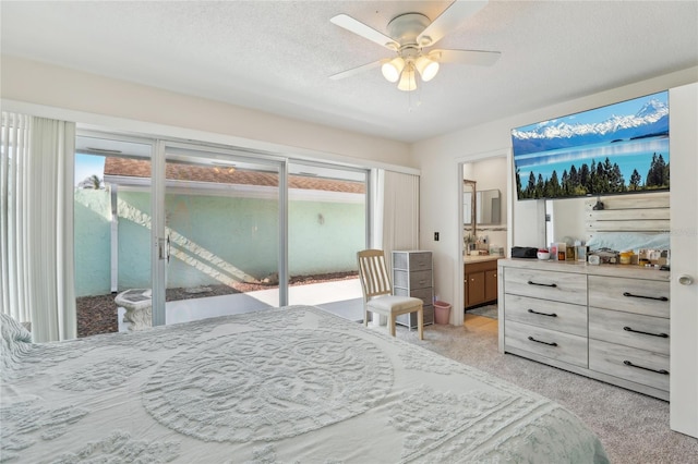 bedroom with light carpet, a textured ceiling, access to exterior, and multiple windows