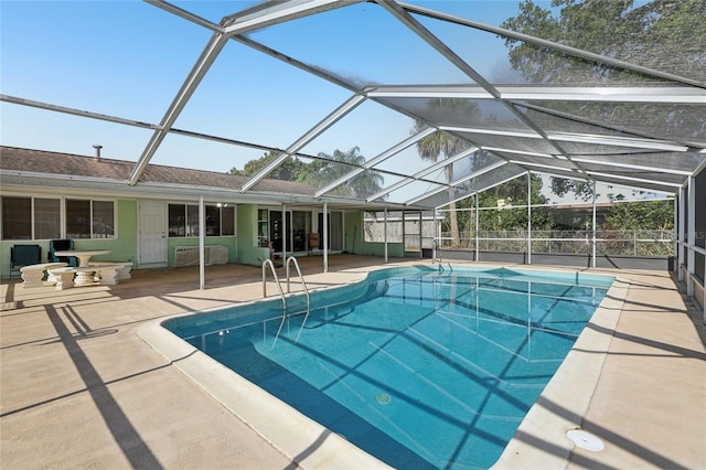 outdoor pool with a lanai and a patio area