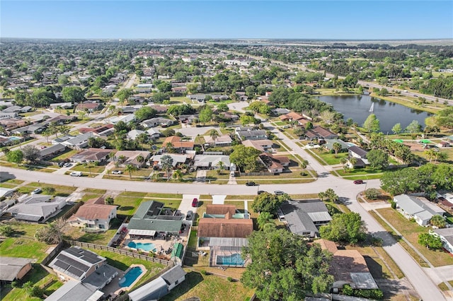 drone / aerial view featuring a water view and a residential view