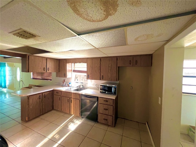 1221 Oak Haven Dr, Altamonte Springs, FL 32714 - kitchen with light countertops, dishwashing machine, a sink, stainless steel microwave, and a peninsula