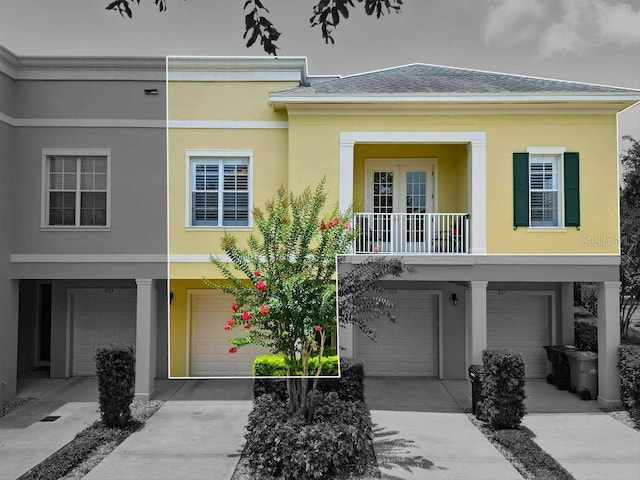 1845 Common Way Rd Unit 28-206, Orlando, FL 32814 - view of property with an attached garage, driveway, stucco siding, and roof with shingles