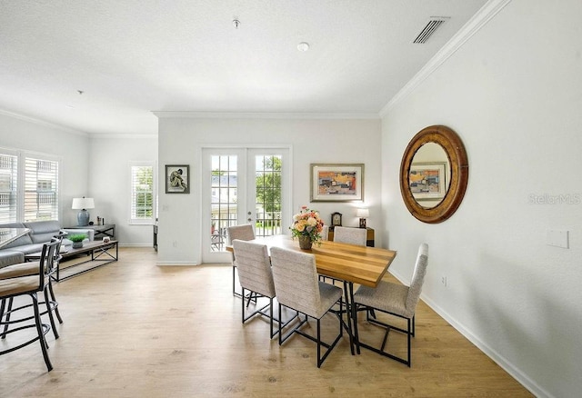 1845 Common Way Rd Unit 28-206, Orlando, FL 32814 - dining space with ornamental molding, french doors, and light wood-type flooring