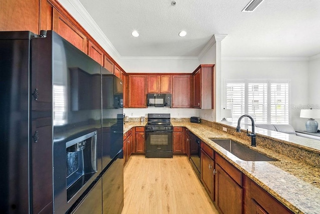 1845 Common Way Rd Unit 28-206, Orlando, FL 32814 - kitchen with black appliances, light wood-style flooring, light stone countertops, ornamental molding, and recessed lighting