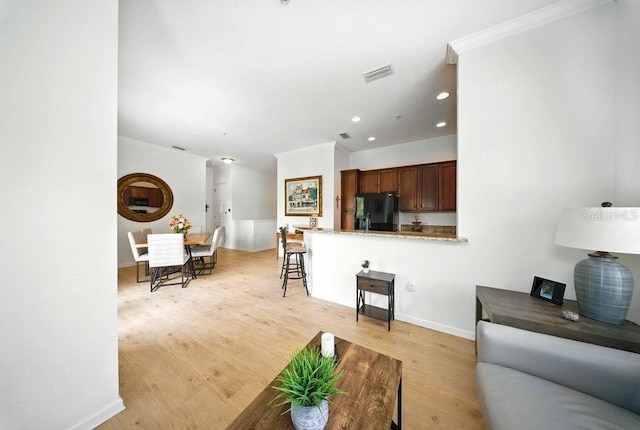 1845 Common Way Rd Unit 28-206, Orlando, FL 32814 - living area featuring crown molding, light wood-style floors, and recessed lighting