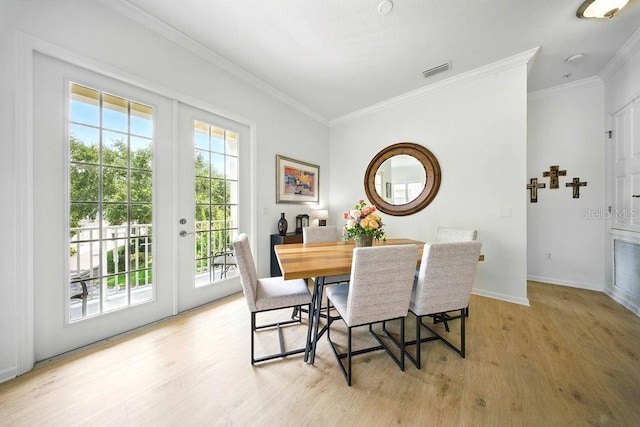 1845 Common Way Rd Unit 28-206, Orlando, FL 32814 - dining room featuring light wood-type flooring, crown molding, and french doors