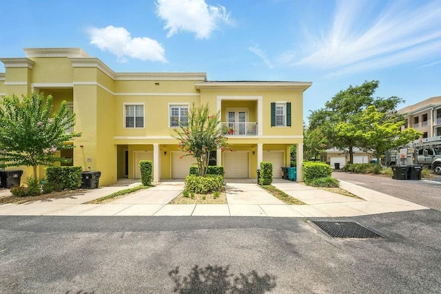 1845 Common Way Rd Unit 28-206, Orlando, FL 32814 - multi unit property with a garage, stucco siding, driveway, and a balcony
