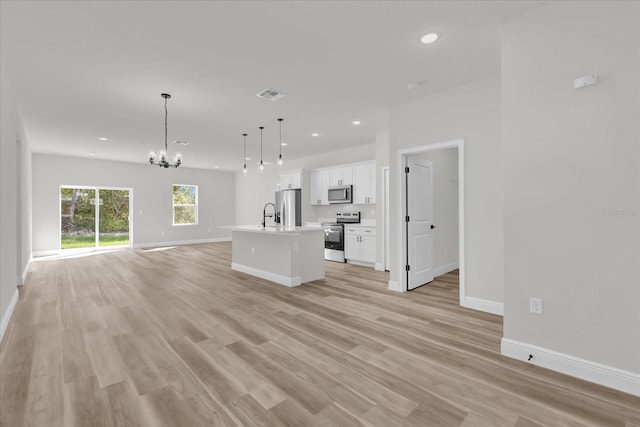15823 SW 27th Avenue Rd, Ocala, FL 34473 - kitchen featuring visible vents, baseboards, open floor plan, a chandelier, and stainless steel appliances