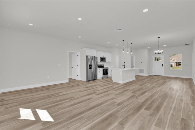 15823 SW 27th Avenue Rd, Ocala, FL 34473 - unfurnished living room featuring a notable chandelier, recessed lighting, baseboards, light wood-type flooring, and visible vents