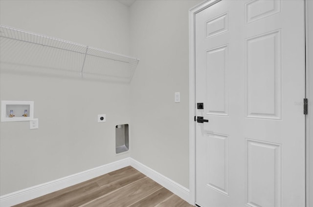 15823 SW 27th Avenue Rd, Ocala, FL 34473 - laundry area with hookup for an electric dryer, laundry area, wood finished floors, baseboards, and hookup for a washing machine