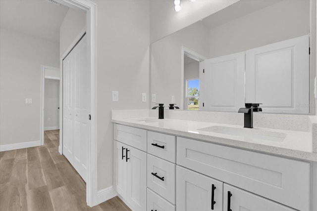 15823 SW 27th Avenue Rd, Ocala, FL 34473 - full bath with double vanity, baseboards, a sink, and wood finished floors