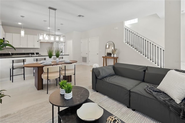 living area with stairway and visible vents