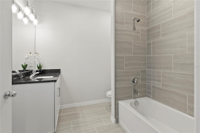 bathroom with shower / bathing tub combination, baseboards, toilet, and vanity