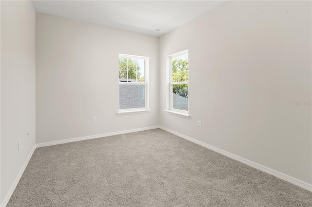 empty room with carpet floors and baseboards