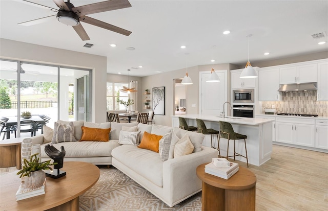 2729 Serenity Meadow Dr, Kissimmee, FL 34744 - living area featuring light wood-type flooring, a ceiling fan, visible vents, and recessed lighting