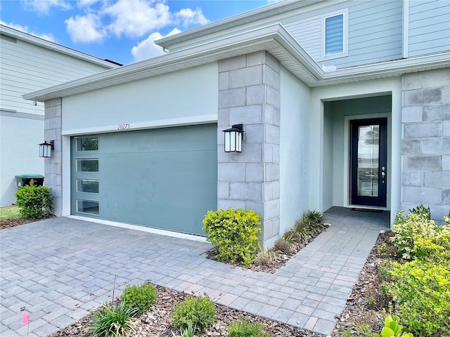 10275 Park Estates Ave, Orlando, FL 32836 - doorway to property featuring a garage and decorative driveway
