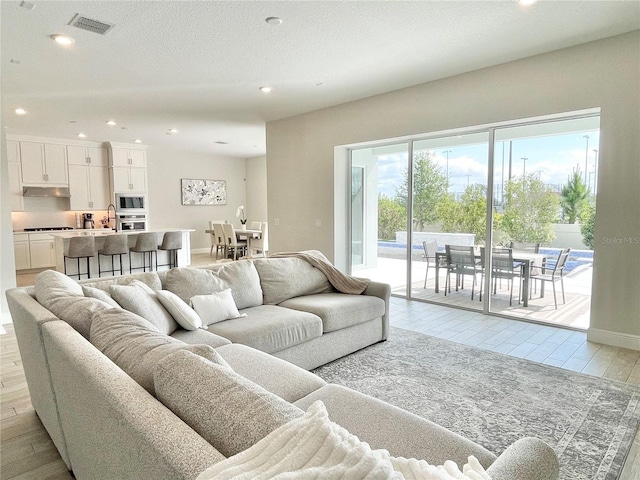 10275 Park Estates Ave, Orlando, FL 32836 - living area featuring light wood-style floors, recessed lighting, and visible vents