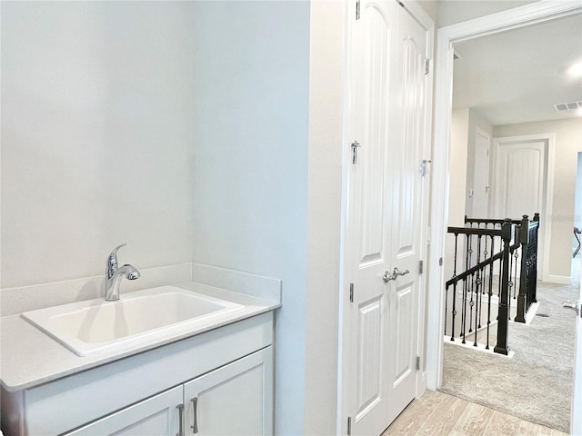 10275 Park Estates Ave, Orlando, FL 32836 - bathroom with visible vents, wood finished floors, and vanity
