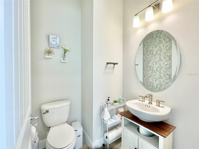 10275 Park Estates Ave, Orlando, FL 32836 - half bathroom with toilet, baseboards, and vanity