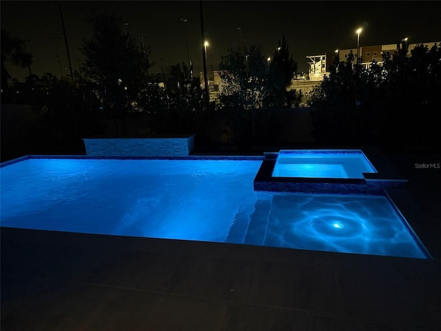 10275 Park Estates Ave, Orlando, FL 32836 - pool at night with a pool with connected hot tub