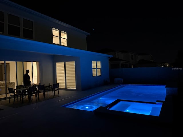 10275 Park Estates Ave, Orlando, FL 32836 - pool at twilight with a patio, a pool with connected hot tub, and fence private yard