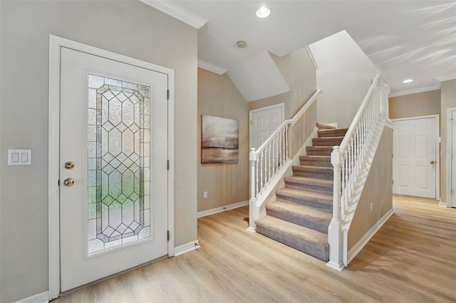 entrance foyer with crown molding, stairs, wood finished floors, baseboards, and recessed lighting