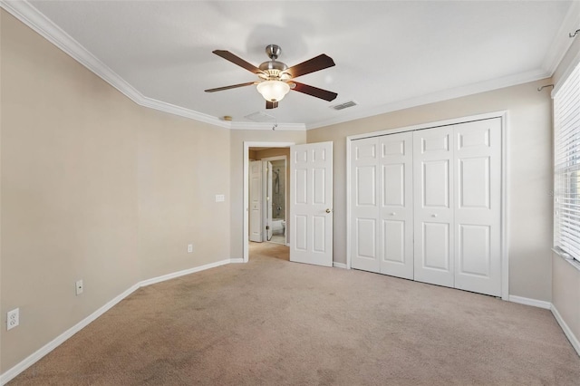 unfurnished bedroom with baseboards, visible vents, ornamental molding, and carpet