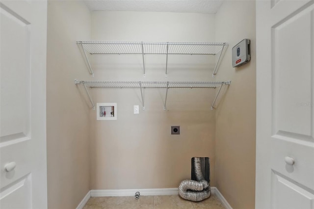 clothes washing area featuring washer hookup, laundry area, tile patterned floors, baseboards, and hookup for an electric dryer