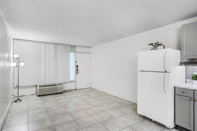 43420 Hwy 27 Unit 121, Davenport, FL 33837 - interior space with baseboards, a wall mounted air conditioner, and a textured ceiling