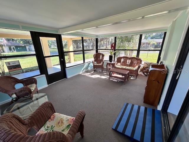 sunroom / solarium with outdoor lounge area and carpet