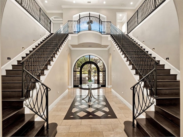 971 Golden Bear Dr, Reunion, FL 34747 - tiled foyer entrance featuring stairway, a high ceiling, french doors, arched walkways, and baseboards