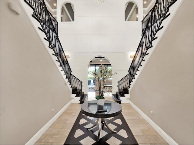 971 Golden Bear Dr, Reunion, FL 34747 - entryway with stairway, arched walkways, and a towering ceiling