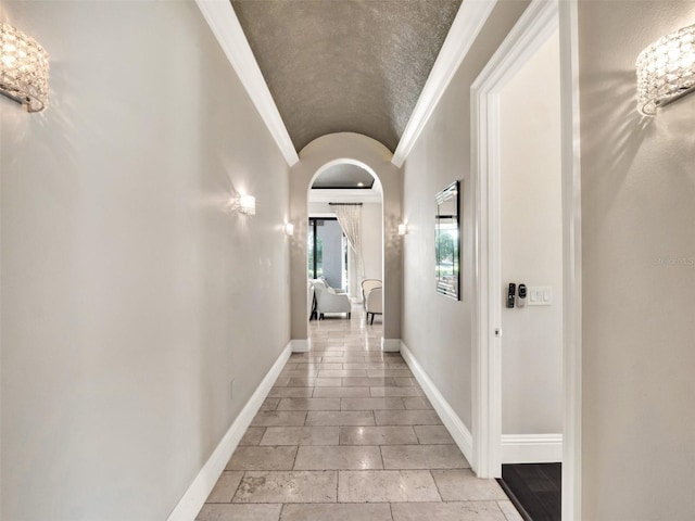 971 Golden Bear Dr, Reunion, FL 34747 - corridor featuring arched walkways, lofted ceiling, crown molding, and baseboards