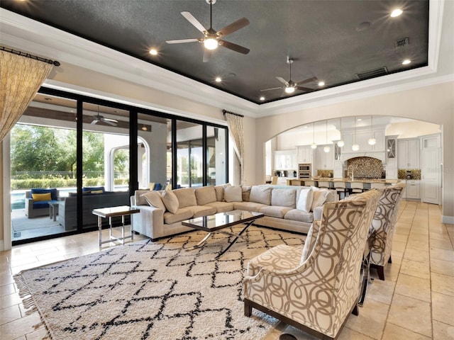 971 Golden Bear Dr, Reunion, FL 34747 - living area with arched walkways, a ceiling fan, and ornamental molding