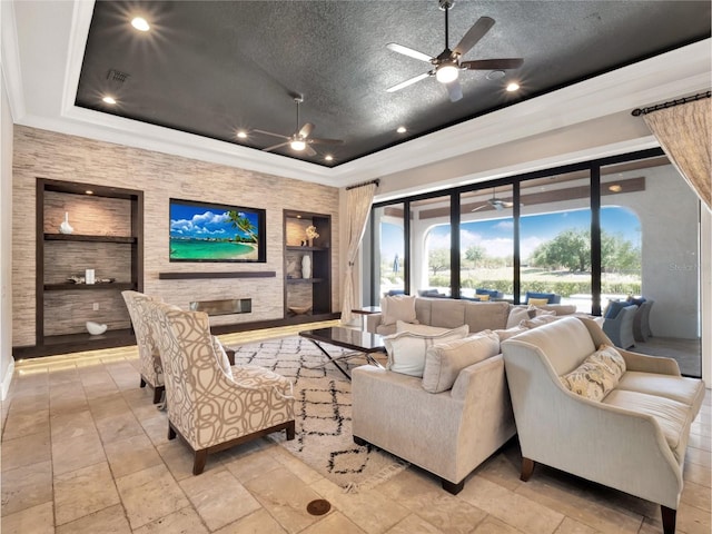 971 Golden Bear Dr, Reunion, FL 34747 - living area featuring a textured ceiling, visible vents, built in features, ceiling fan, and a raised ceiling