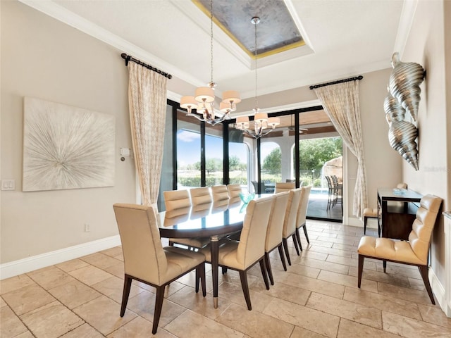 971 Golden Bear Dr, Reunion, FL 34747 - dining area with a chandelier, baseboards, ornamental molding, and a tray ceiling