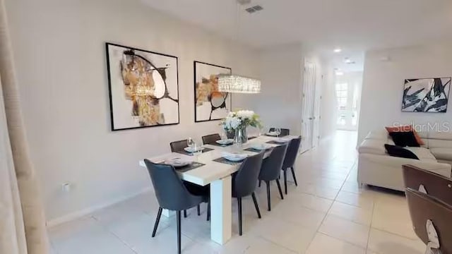 dining room featuring baseboards, visible vents, and light tile patterned floors