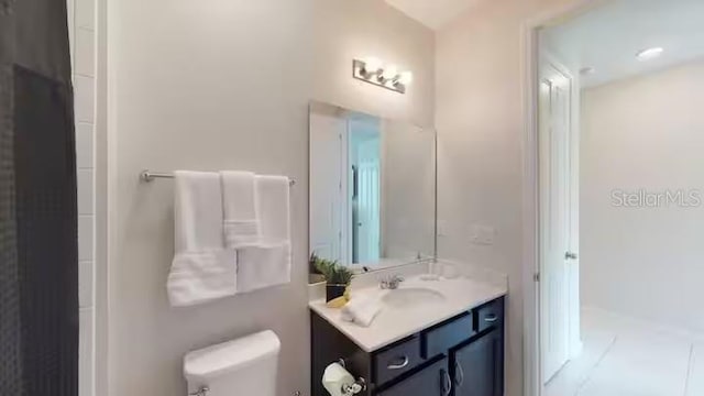 full bathroom featuring vanity and toilet