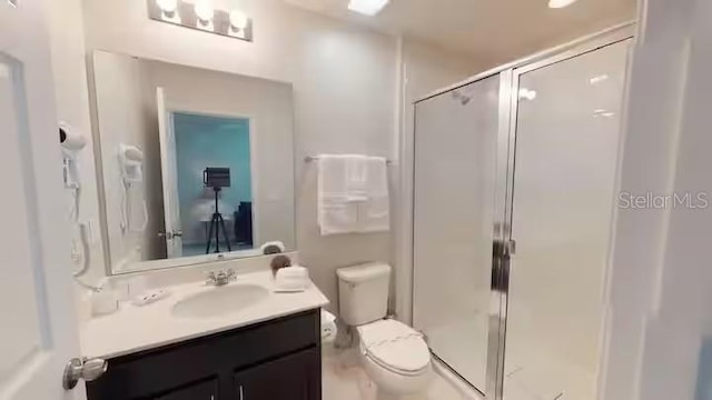full bath with a shower stall, toilet, and vanity