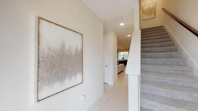 stairway featuring tile patterned flooring and recessed lighting