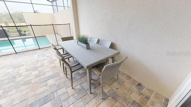 balcony featuring outdoor dining area and a patio