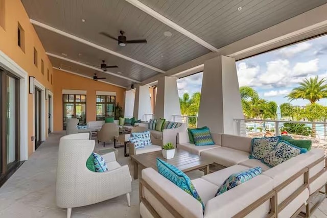 view of patio with an outdoor living space and ceiling fan