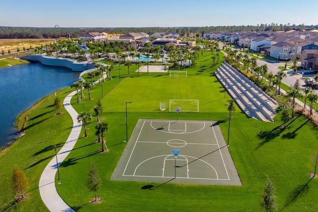 birds eye view of property with a water view and a residential view