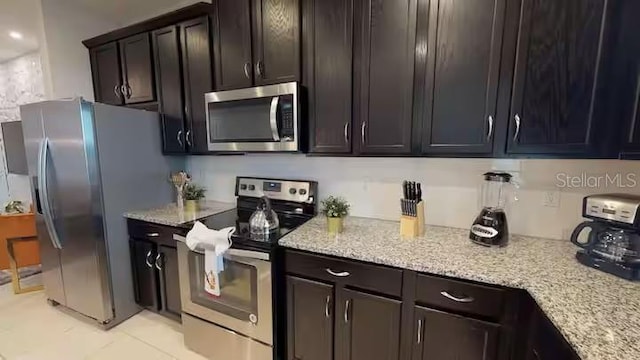 kitchen featuring light stone countertops and appliances with stainless steel finishes