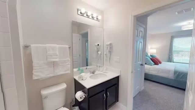bathroom featuring ensuite bath, toilet, and vanity