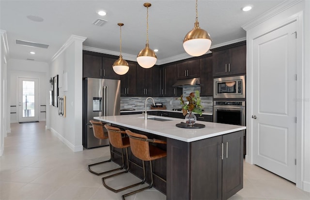 2741 Serenity Meadow Dr, Kissimmee, FL 34744 - kitchen featuring under cabinet range hood, visible vents, a sink, crown molding, and appliances with stainless steel finishes