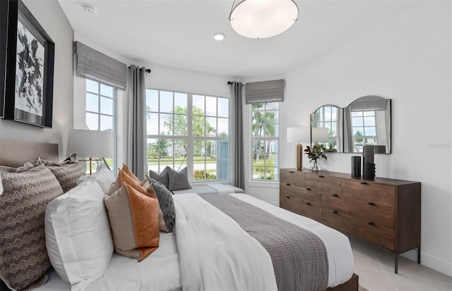 2741 Serenity Meadow Dr, Kissimmee, FL 34744 - bedroom featuring baseboards, light tile patterned floors, and multiple windows